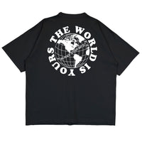 Heavyweight cotton tee in black featuring the APT.4B Globe logo. Represents the brand's journey from local Queens roots to global influence.