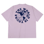 Heavyweight cotton tee in pale grape purple featuring the APT.4B Globe logo. Represents the brand's journey from local Queens roots to global influence.
