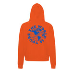 Heavyweight hoodie in orange featuring the APT.4B Globe logo. Represents the brand's journey from local Queens roots to global influence.