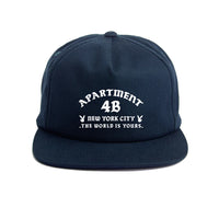 Navy snapback cap with printed Rocksteady logo. Classic 5-panel construction representing NYC heritage.